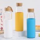 New single-wall glass, bamboo lid with handle, outdoor portable, silicone sleeve, glass water bottle, wholesale.
